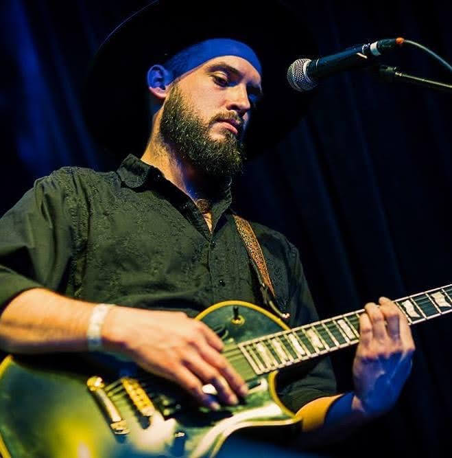 Ben Meyer performing on a green electric guitar