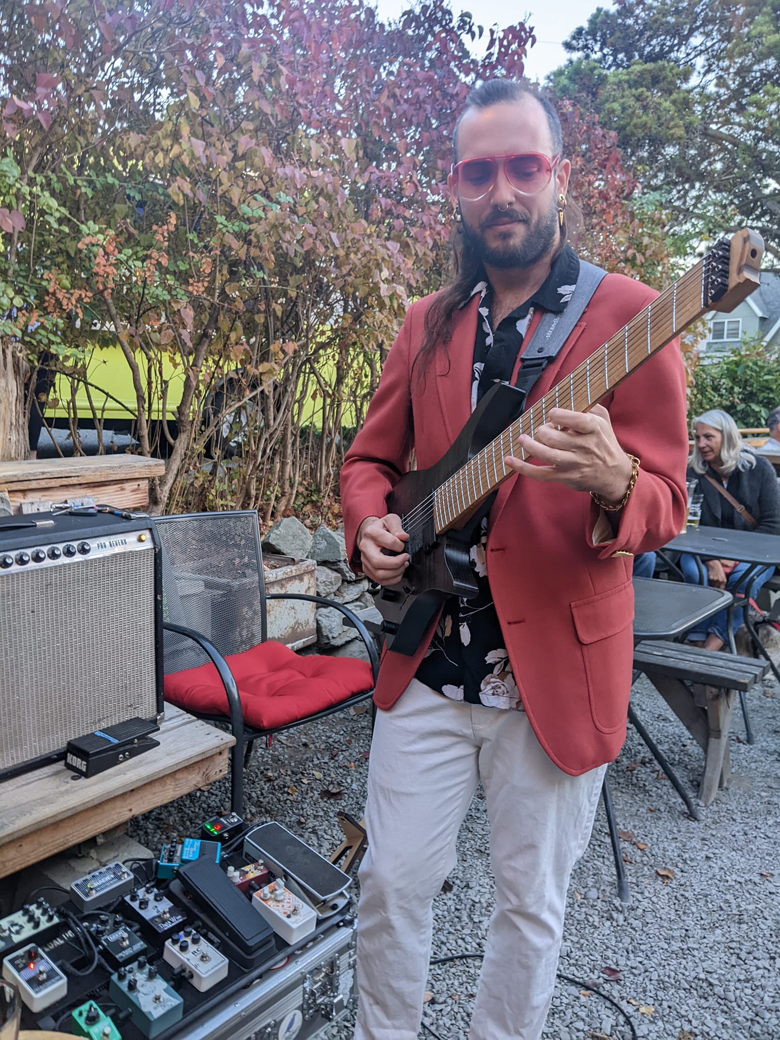 Ben Meyer performing outdoors in a red blazer