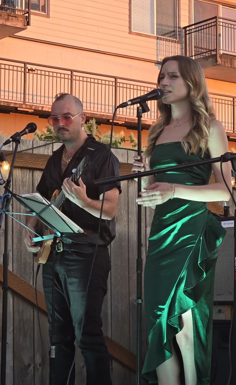 De Dream vocalist Sage and guitarist Ben Meyer performing outdoors