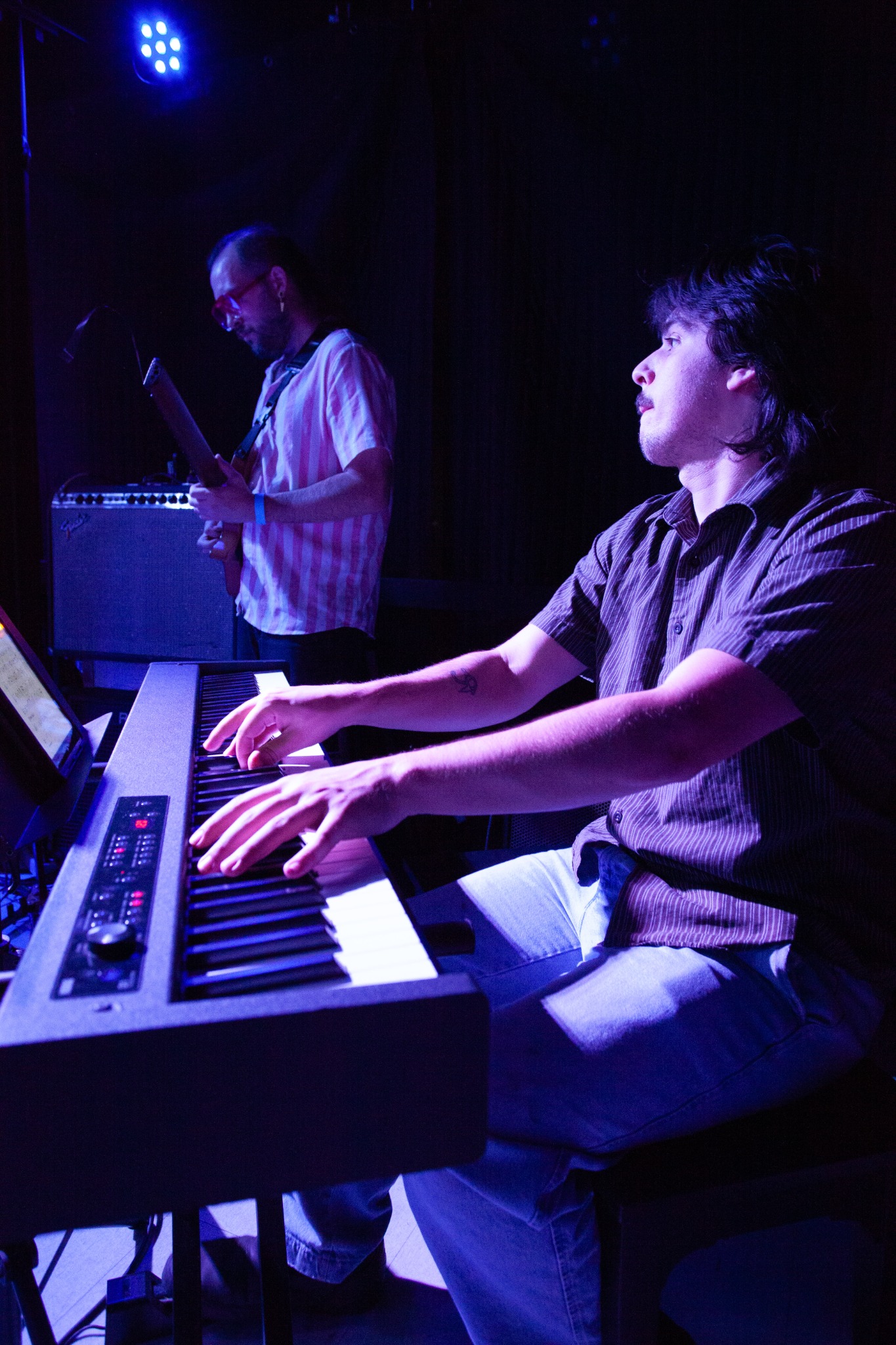 Smile Aisle performing under blue stage lights