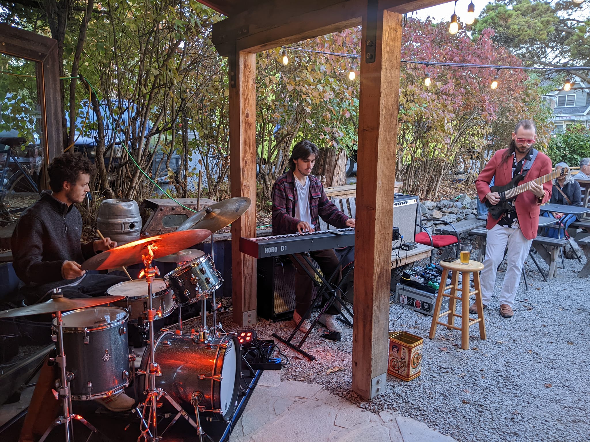 Smile Aisle trio performing on an outdoor patio